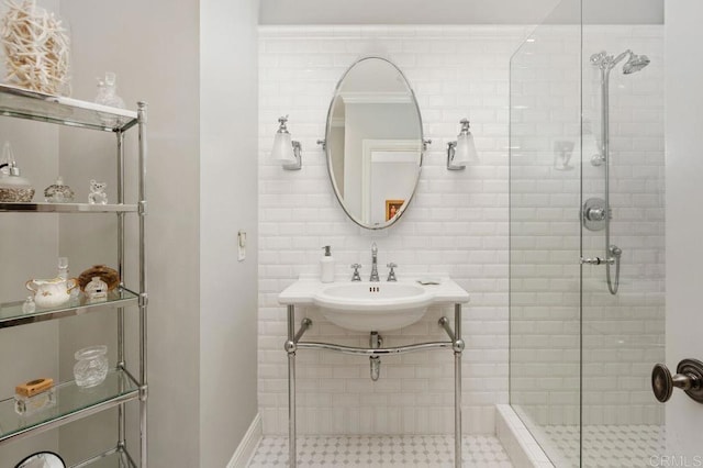 bathroom with ornamental molding, walk in shower, and sink