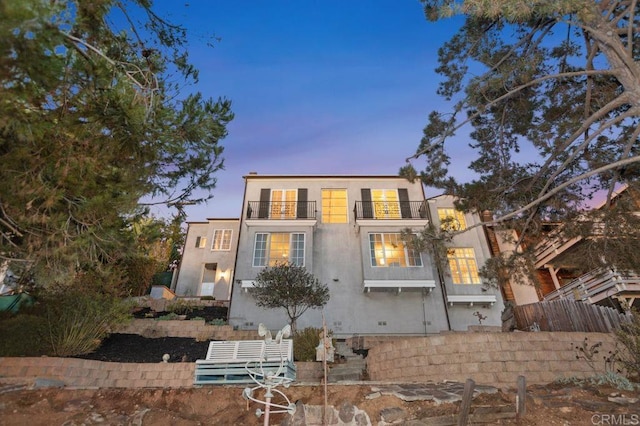 view of front of house featuring a balcony