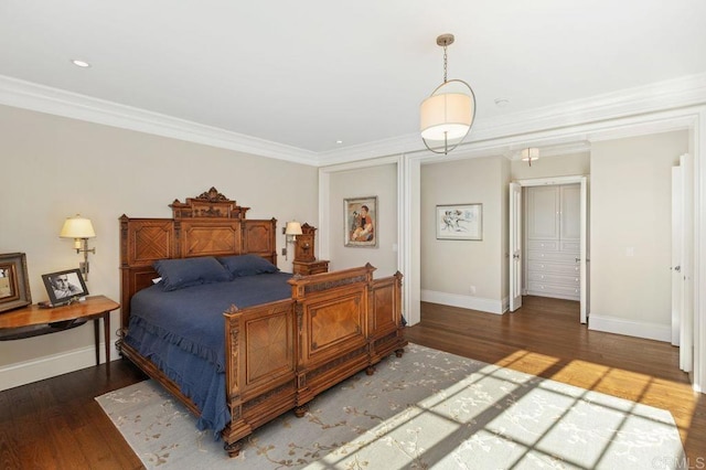 bedroom featuring dark wood-type flooring, a closet, and crown molding