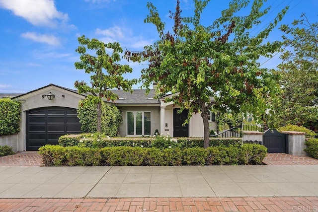 2045 W California St, San Diego, CA 92110 - view of front of property with stucco siding, an attached garage, and a fenced front yard