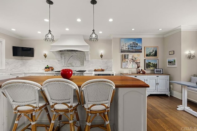 2045 W California St, San Diego, CA 92110 - kitchen with butcher block countertops, custom exhaust hood, recessed lighting, ornamental molding, and decorative backsplash