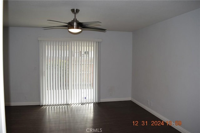 empty room with dark wood-type flooring and ceiling fan