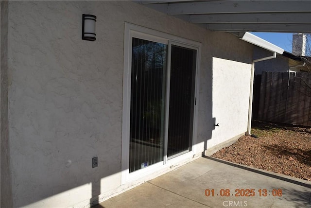 property entrance featuring a patio area