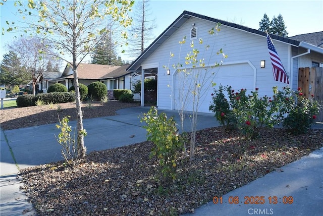 view of side of home featuring a garage