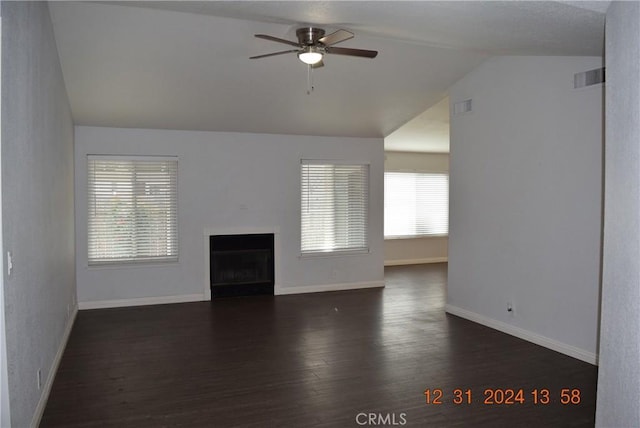 unfurnished living room with ceiling fan, vaulted ceiling, and dark hardwood / wood-style floors