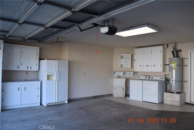 garage with white refrigerator with ice dispenser, independent washer and dryer, a garage door opener, water heater, and sink