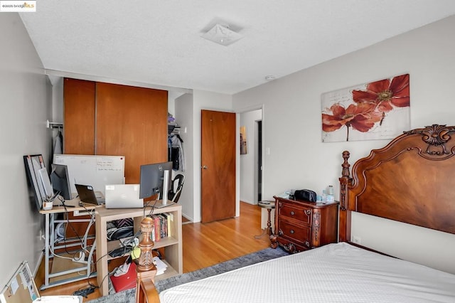 bedroom with a closet and light hardwood / wood-style flooring