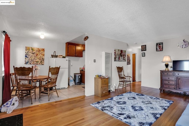 interior space with a textured ceiling and light tile patterned floors