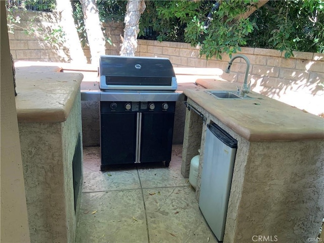 view of patio / terrace featuring an outdoor kitchen, sink, and a grill