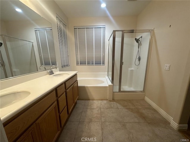 bathroom with vanity, tile patterned flooring, and plus walk in shower