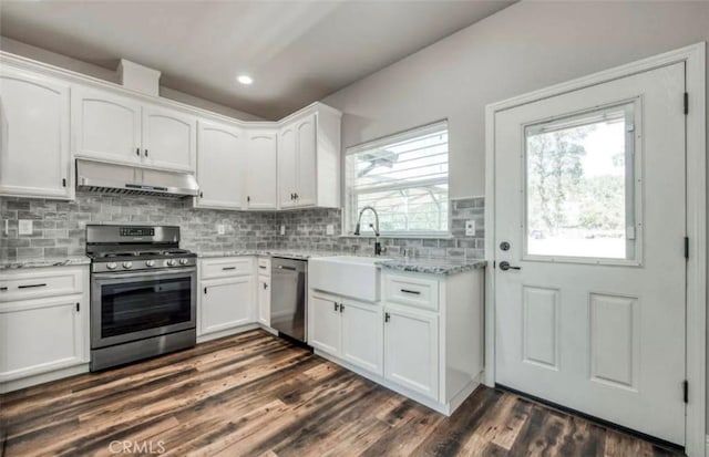 kitchen featuring appliances with stainless steel finishes, white cabinetry, and sink