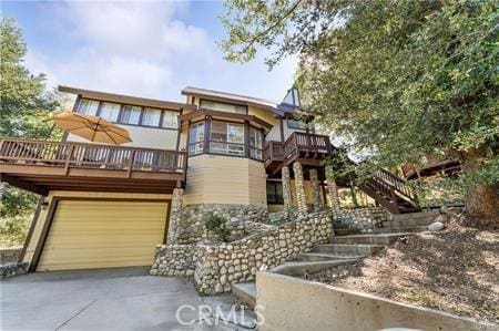 view of front facade featuring a deck and a garage