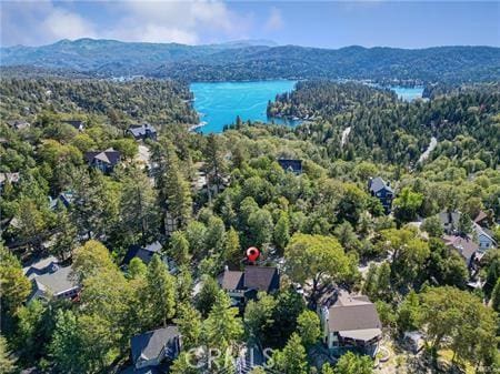 birds eye view of property with a water and mountain view