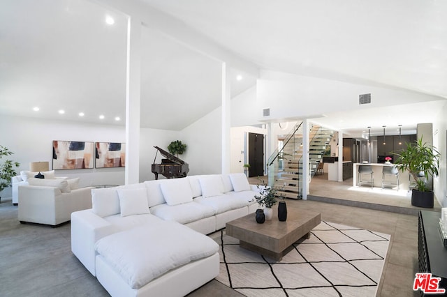 living room featuring vaulted ceiling with beams