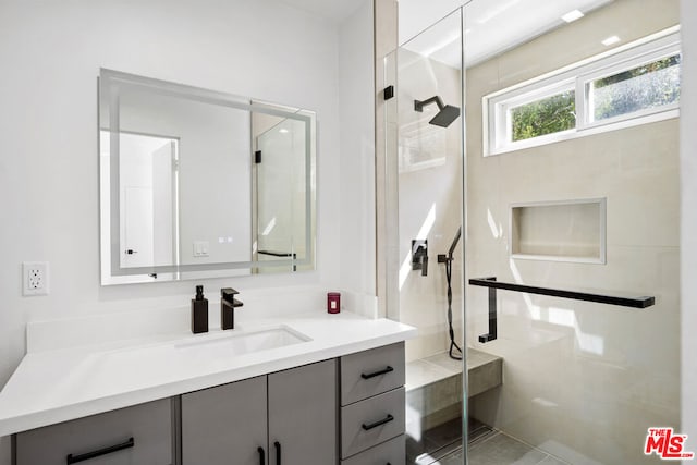 bathroom with an enclosed shower and vanity