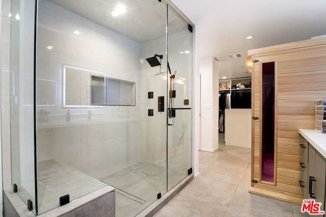 bathroom featuring tile patterned flooring and walk in shower