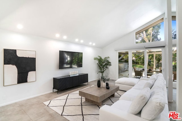 living room with high vaulted ceiling