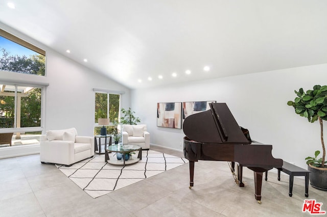 living area with light tile patterned floors and high vaulted ceiling