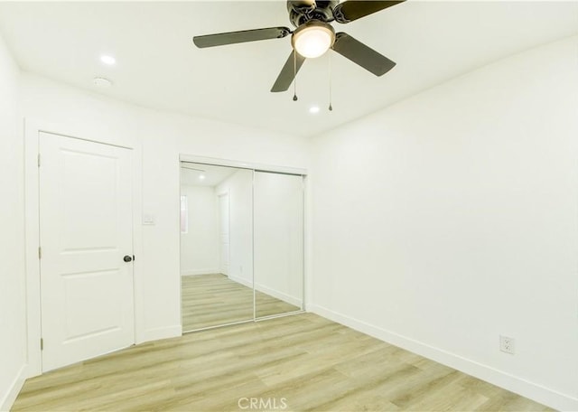 unfurnished bedroom with a closet, ceiling fan, and light hardwood / wood-style floors