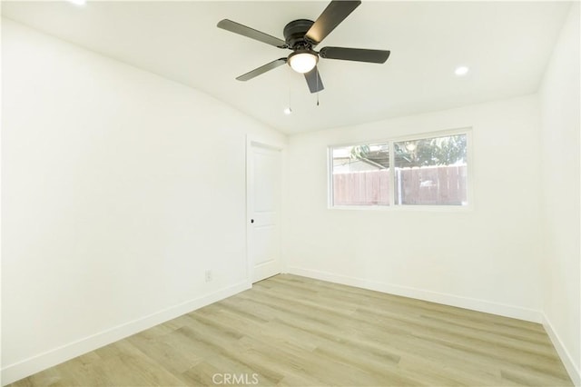 empty room with ceiling fan and light hardwood / wood-style floors