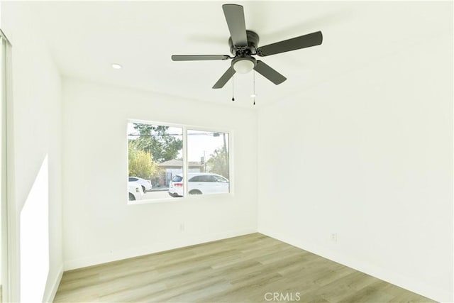 spare room featuring light wood-type flooring and ceiling fan