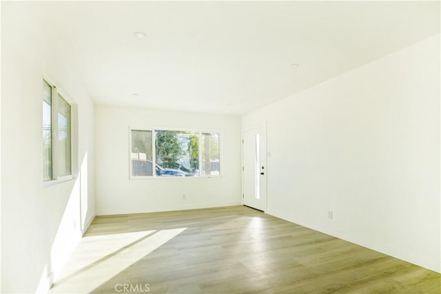 spare room with light hardwood / wood-style flooring