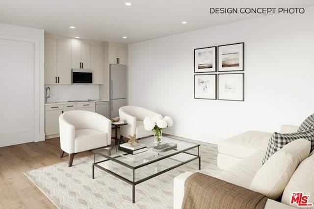 living room featuring light hardwood / wood-style flooring and sink