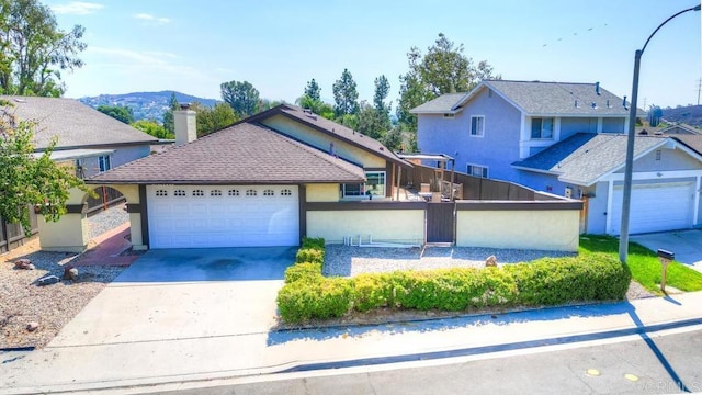 view of front of home with a garage and a mountain view