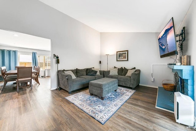 living room featuring hardwood / wood-style floors and vaulted ceiling