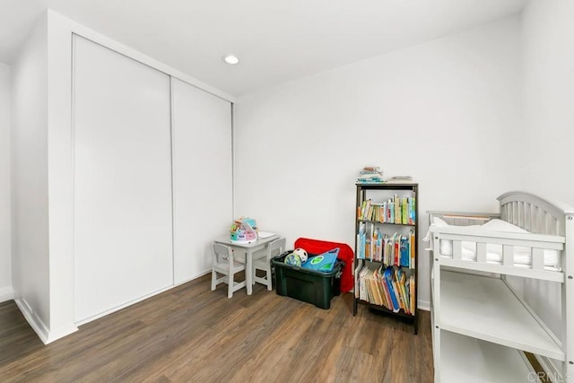 bedroom with dark hardwood / wood-style flooring