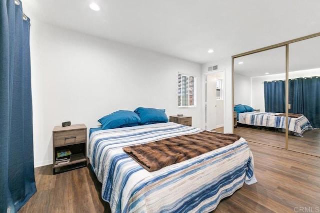 bedroom featuring a closet and dark hardwood / wood-style floors