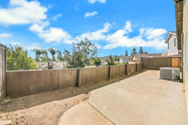 view of yard featuring central AC unit and a patio