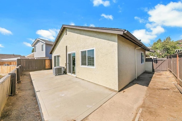 rear view of property with a patio and central AC