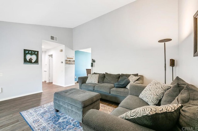 living room featuring hardwood / wood-style floors and high vaulted ceiling