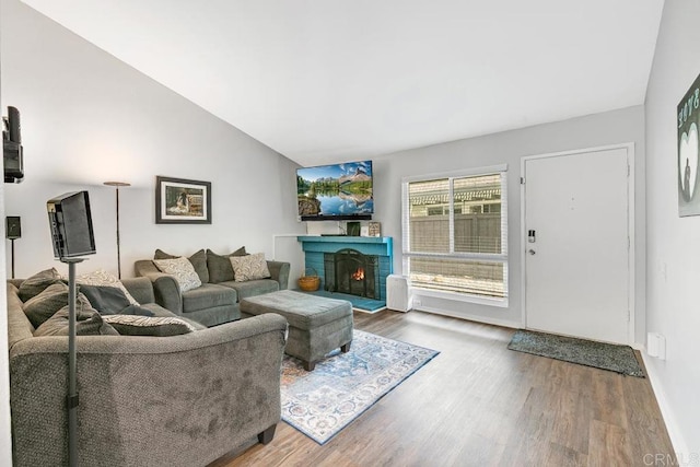 living room featuring hardwood / wood-style floors and vaulted ceiling