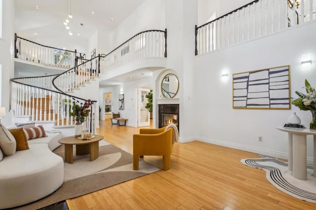 living room with hardwood / wood-style flooring and a high ceiling