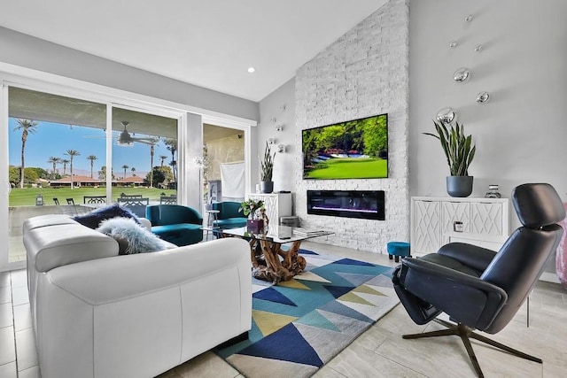 living room featuring lofted ceiling, a fireplace, and a healthy amount of sunlight