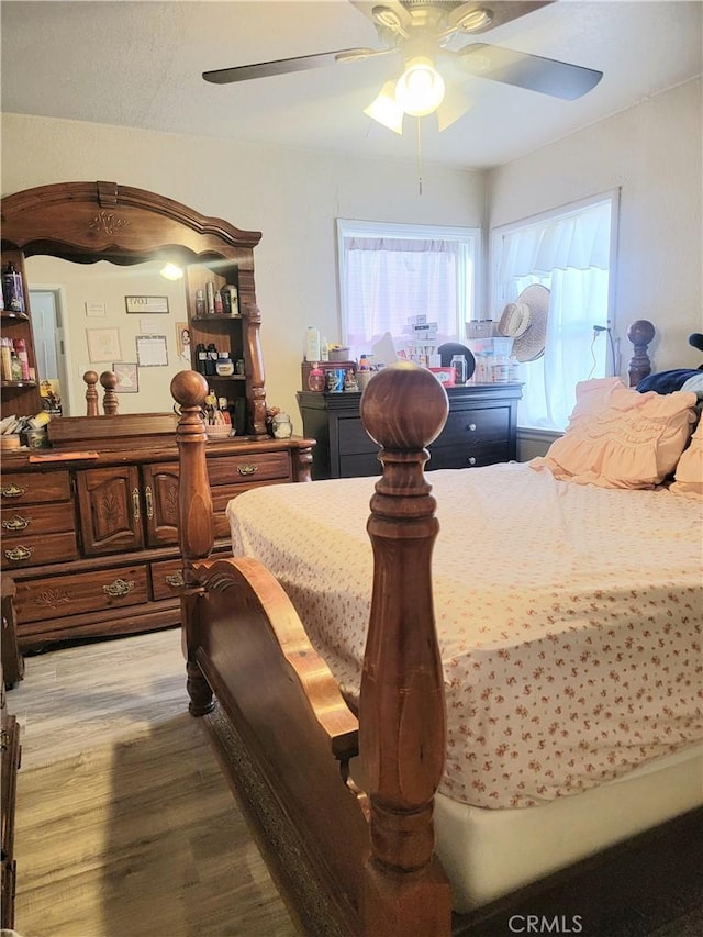 bedroom featuring ceiling fan and light hardwood / wood-style floors