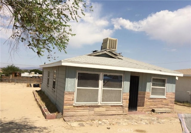 rear view of property featuring cooling unit