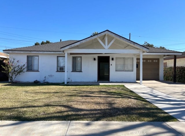 single story home with a porch, a front lawn, and a garage