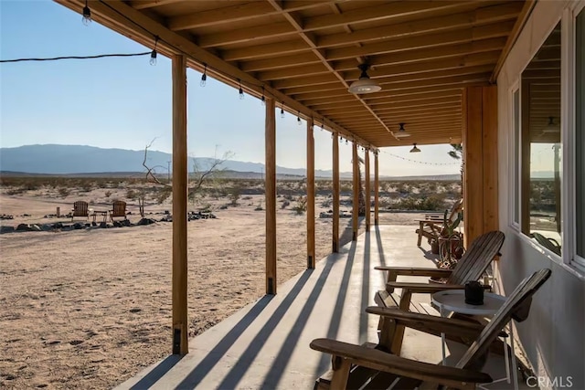 view of patio / terrace with a rural view and a mountain view