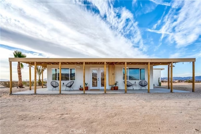 rear view of property with french doors and a patio area