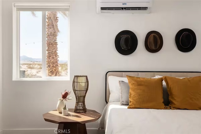 bedroom featuring a wall mounted AC