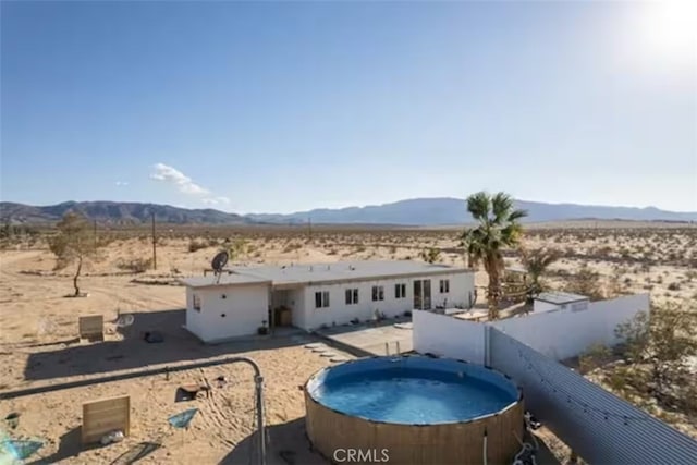 back of property featuring a mountain view