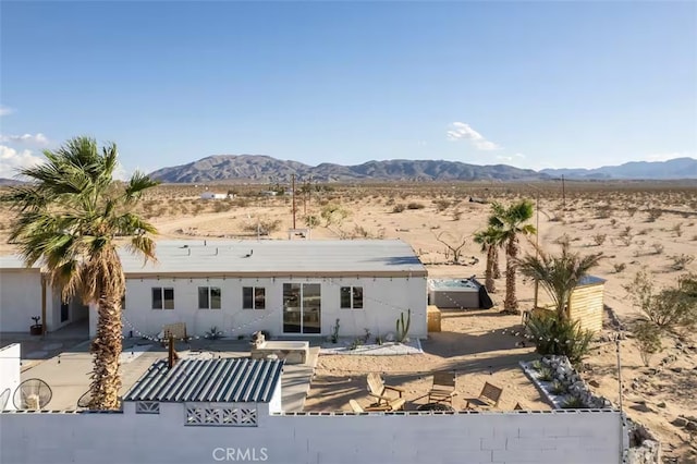 rear view of house featuring a mountain view