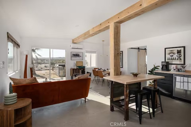 dining room featuring beam ceiling, a barn door, concrete flooring, and an AC wall unit