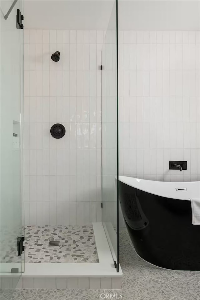 bathroom with tile walls, plus walk in shower, and tile patterned floors