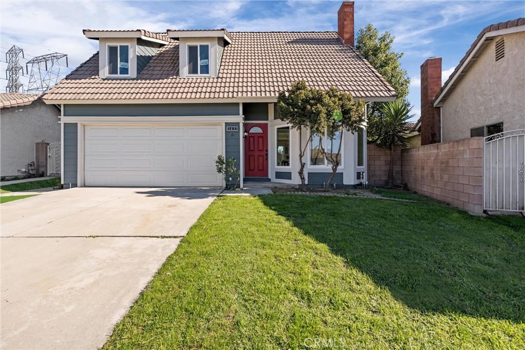 view of front of property with a front yard and a garage