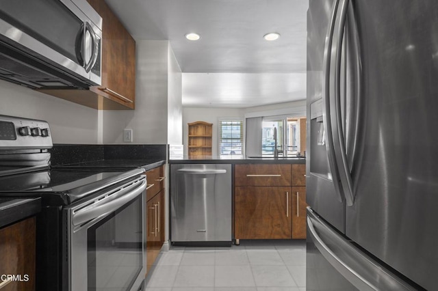 kitchen with light tile patterned flooring and appliances with stainless steel finishes