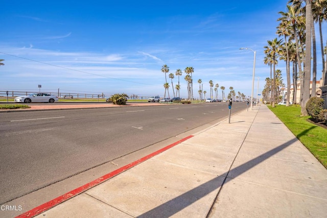 view of street featuring curbs, street lighting, and sidewalks